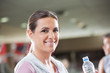 Woman Holding Bottle Of Water At Health Club