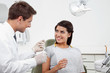 Photo: Dentist Holding Thread While Patient Looking At Him Dentist Holding Thread While Patient Looking At Him