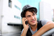 Trendy guy with hat talking on mobile phone