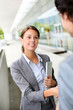 Businesswoman shaking hand to partner