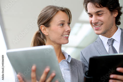 Photo: Business partners meeting outside building Business partners meeting outside building