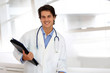 Cheerful student in medicine standing in hospital hallway