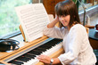 Photo: Portrait of cute little girl at piano. Portrait of cute little girl at piano.