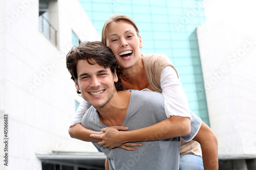 Photo: Man giving piggyback ride to girlfriend Man giving piggyback ride to girlfriend