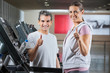 Instructor And Client Showing Thumbs Up Sign In Health Club
