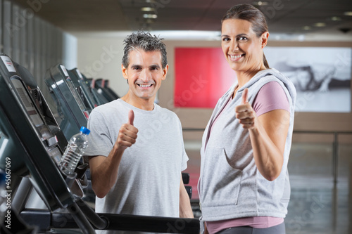 Photo: Instructor And Client Showing Thumbs Up Sign In Health Club Instructor And Client Showing Thumbs Up Sign In Health Club