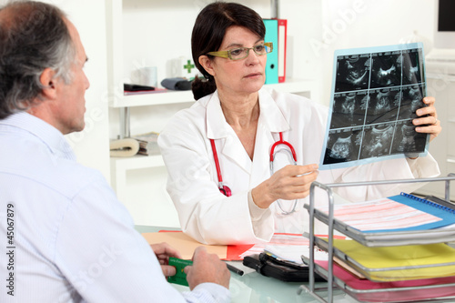 Photo: Female doctor examining x-ray Female doctor examining x-ray
