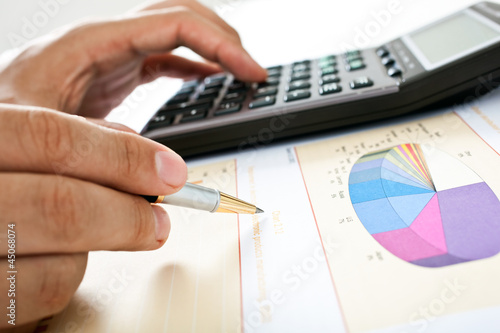 Photo: Examination of a stock market report Examination of a stock market report