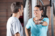 Woman Working Out While Looking At Instructor