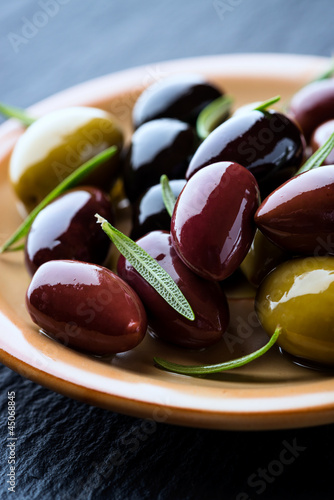 Photo: Marinated olives with rosemary on a plate Marinated olives with rosemary on a plate