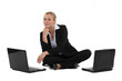 Blond businesswoman sat on the floor with two laptops