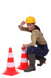 Woman placing traffic cones