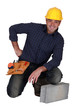 craftsman posing next to a stone block