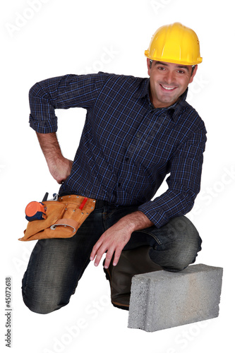 Photo: craftsman posing next to a stone block craftsman posing next to a stone block