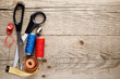 Sewing accessories on wooden background