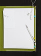 "Earphones, pencil and paper clip on blank paper with file"