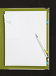 Pencil and paper clip on blank paper with file