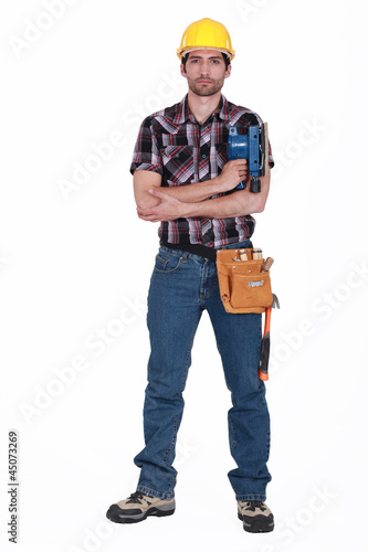 Photo: Portrait of a tradesman holding a sander Portrait of a tradesman holding a sander
