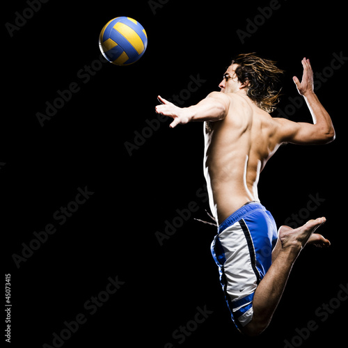 Photo: Studio shot of man jumping to hit soccer ball Studio shot of man jumping to hit soccer ball