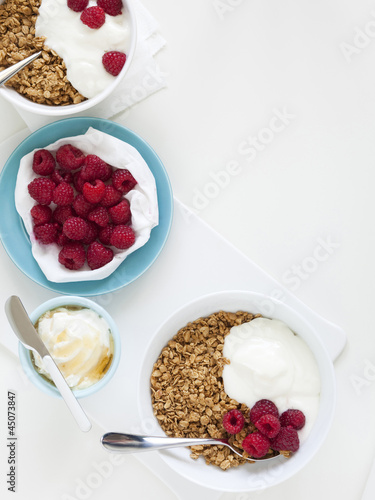 Photo: "Healthy breakfast with cereals and fresh raspberries, studio shot" "Healthy breakfast with cereals and fresh raspberries, studio shot"