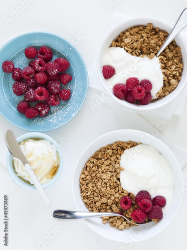 Photo: "Healthy breakfast with cereals and fresh raspberries, studio shot" "Healthy breakfast with cereals and fresh raspberries, studio shot"