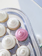 "Cupcakes with frosting on silver tray, close-up, elevated view"