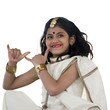 Photo: "Girl (8-9) wearing traditional sari performing figures from indian traditional dance, studio shot" "Girl (8-9) wearing traditional sari performing figures from indian traditional dance, studio shot"