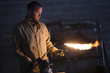 "USA, Utah, Orem, male welder using blowtorch in workshop"