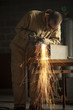 "USA, Utah, Orem, man welding metal in workshop"
