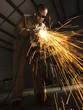 "USA, Utah, Orem, man welding metal in workshop"