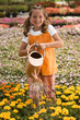 "USA, Utah, Salem, portrait of girl (8-9) watering flowers"