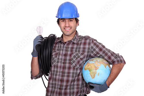 Photo: Eager electrician installing electrical systems abroad Eager electrician installing electrical systems abroad