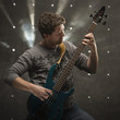 "Young man playing electric guitar, studio shot"