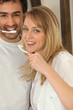 Couple brushing their teeth