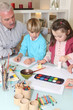 Man watching grandchildren paint