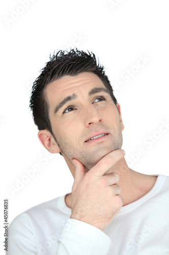 Photo: Doubtful man on white background Doubtful man on white background