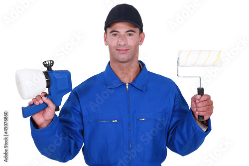 Photo: Man with a roller and paint gun Man with a roller and paint gun