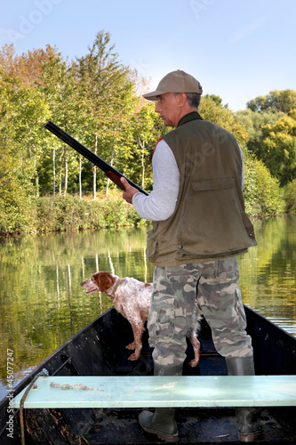 Photo: Hunter on boat with dog Hunter on boat with dog