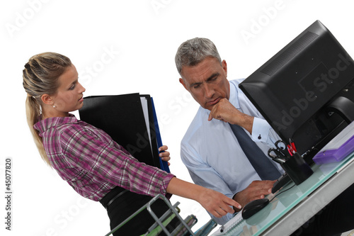 Photo: A boss and his secretary at work. A boss and his secretary at work.