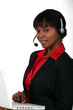Businesswoman with a laptop and headset