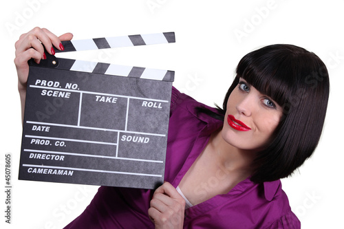 Photo: Woman holding up a clapperboard Woman holding up a clapperboard