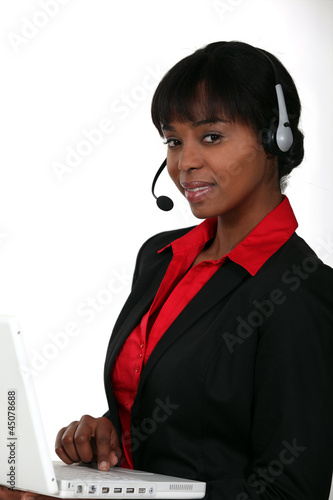 Photo: Businesswoman with a laptop and headset Businesswoman with a laptop and headset