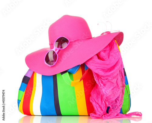 Photo: Beach bag with accessories isolated on white Beach bag with accessories isolated on white