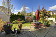 Spring house back yard with red chairs and umbrella