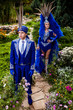 Couple in expensive dark blue costume of illusionist pose