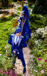 Couple in expensive dark blue costume of illusionist pose