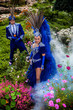 Photo: Couple in expensive dark blue costume of illusionist pose Couple in expensive dark blue costume of illusionist pose