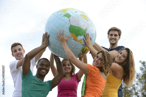 Photo: Group of young people holding a globe earth Group of young people holding a globe earth