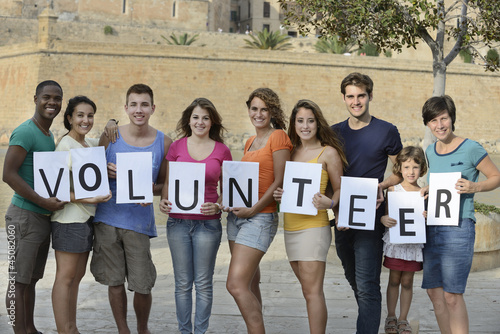 Photo: happy and diverse volunteer group happy and diverse volunteer group