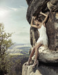 Photo: Blonde beauty posing on a dangerous rock Blonde beauty posing on a dangerous rock